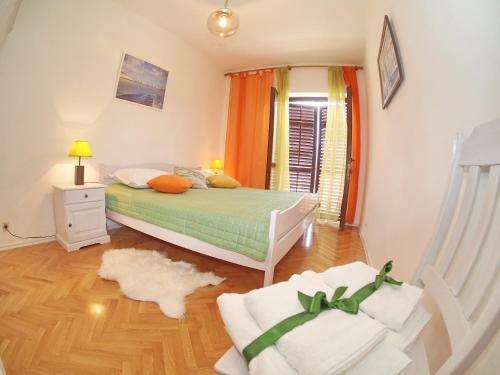 a bedroom with a bed and a rug on the floor at Apartments K & K Dubrovnik in Dubrovnik