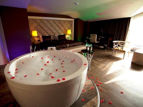a hotel room with a tub with red roses on the floor at Taba Luxury Suites and Hotel in Istanbul