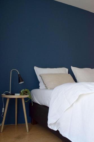 a bedroom with two beds and a table with a lamp at Villa Scorpio in Rijs