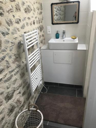 a bathroom with a sink and a mirror at Chez Natacha et Adrien in Regnéville-sur-Mer