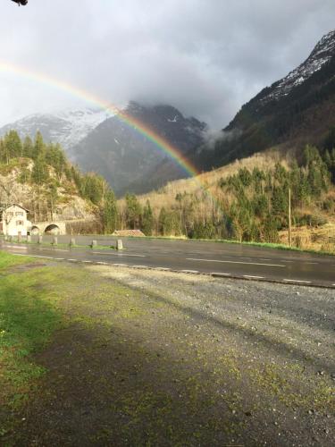 a rainbow on the side of a road at "Terrasse" Nessental in Gadmen