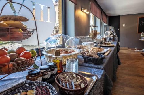 a buffet line with baskets of bread and other food at Park Hotel Airport in Charleroi