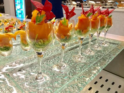 a row of wine glasses with fruit in them at Novotel Jazan in Jazan