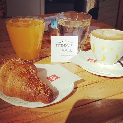 a table with a plate of bread and a cup of coffee at Terry's House in Nuoro