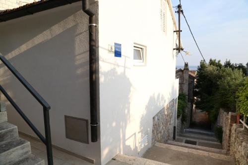 a stairway leading up to a white building at Apartments Sunset in Hvar
