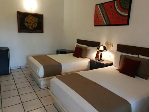 Ein Bett oder Betten in einem Zimmer der Unterkunft Hotel Hacienda de Melaque