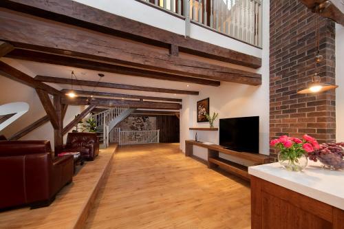 a living room with wooden floors and a brick wall at Blacksmith Old Town Apartments in Tallinn