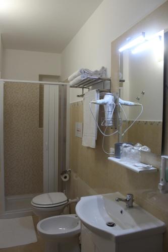 a bathroom with a sink and a toilet and a mirror at B&B La Casa Du Barone in Falcone