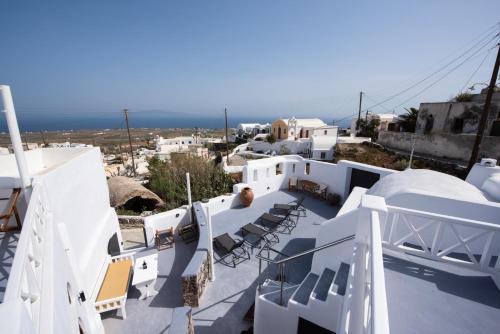 a view from the roof of a house with chairs at Caves 1880 in Oia