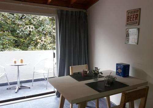 a dining room with a table and a large window at Cozy Apartment in Belgrano in Buenos Aires