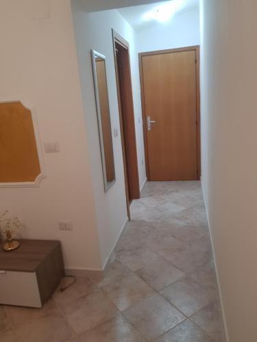a hallway with two doors and a tiled floor at B&B Dimora del centro in Scalea
