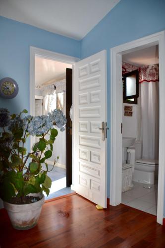 a bathroom with a door and a potted plant in a room at Bungalow en Playa del Ingles in Playa del Ingles