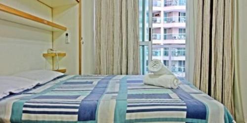 a bedroom with a bed with a cat toy on it at Apartamento Marina in Rio de Janeiro