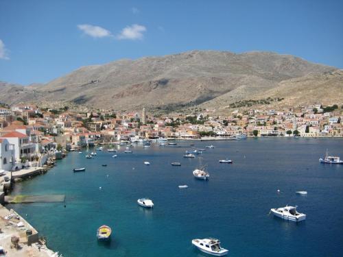 a group of boats in a large body of water at Cohili Villa in Halki