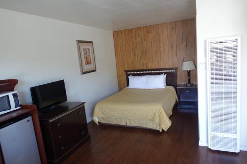a hotel room with a bed and a television at Discovery Inn - Eureka in Eureka