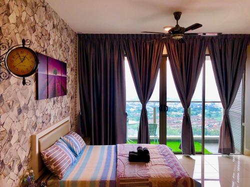 a bedroom with a bed with a clock and windows at Buff Evo Soho Bangi Sentral with NETFLIX & WiFi in Bangi