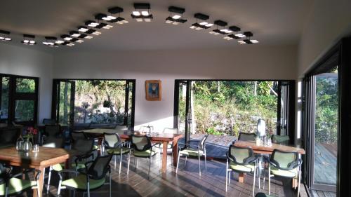 a room with tables and chairs and large windows at Coconut Beach Homestay in Beinan