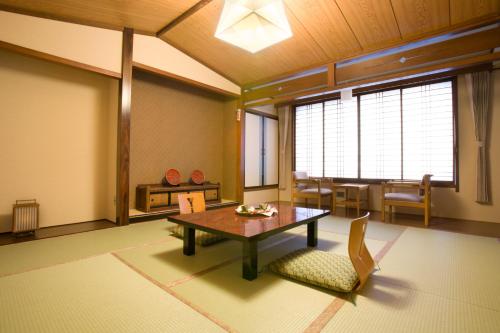 a living room with a table and a dining room at Onyado Tsutaya in Kiso