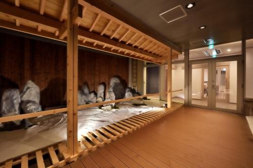 a room filled with lots of stuffed animals on display at Cabin & Capsule Hotel J-SHIP Osaka Namba in Osaka