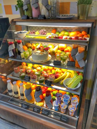 a display case in a store filled with fruits and vegetables at IBB Hotel Gdańsk in Gdańsk