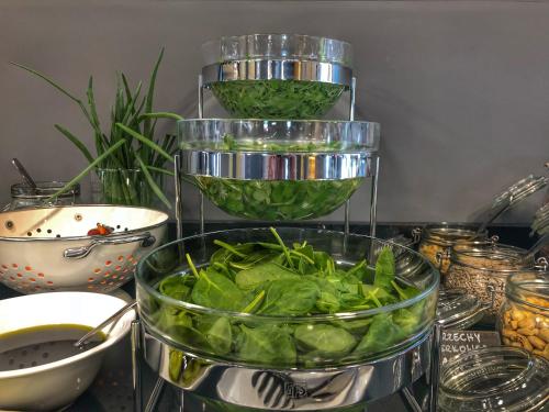 a bunch of green lettuce in a bowl on a table at IBB Hotel Gdańsk in Gdańsk