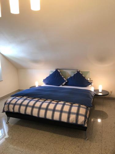 a bedroom with a large bed with blue pillows at Burgblick in Bernkastel-Kues