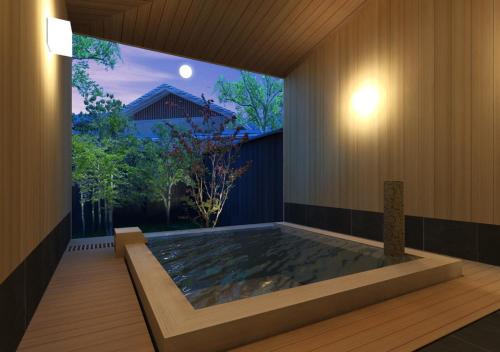 a large swimming pool in a house with a large window at Hotel Shiki no Yakata Nasu in Nasu