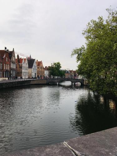a river in a city with a bridge and buildings at Enroute367 in Varsenare