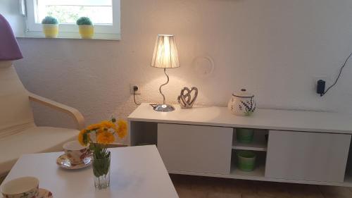 a living room with a table with a lamp on it at Apartman Duba in Senj