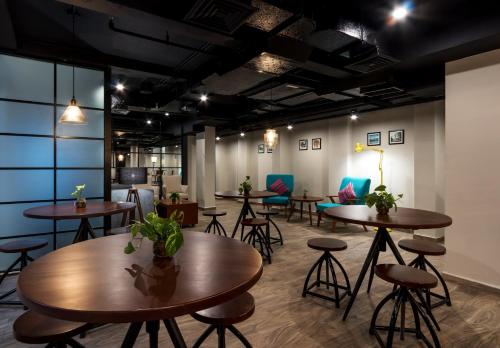 a group of tables and chairs in a room at S Loft Manado in Manado