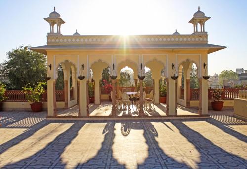 a gazebo with a table and chairs at Alsisar Haveli - Heritage Hotel in Jaipur