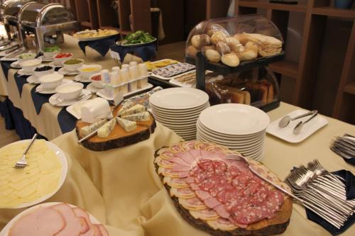 a long table with plates of food on it at Ararat Resort Tsaghkadzor in Tsaghkadzor