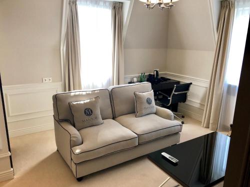 a living room with a couch and a table at Hotel Mansor in Ząbki