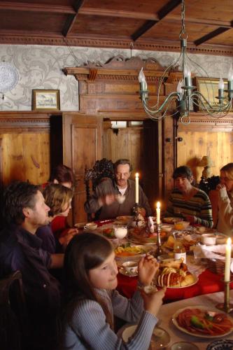 a group of people sitting around a table eating food at Lindenhof in Murau