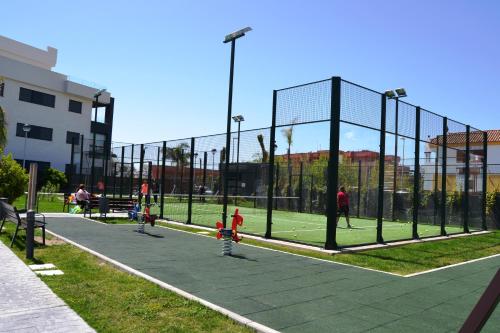 a group of children playing on a tennis court at Residencial Costa Doñana (Sanlucar de Barrameda) in Sanlúcar de Barrameda