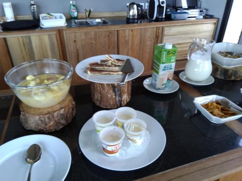 a table topped with plates of food and drinks at Couleur Café in Antsirabe