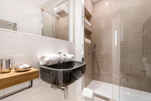 a bathroom with a black sink and a shower at Le Stanze Di Elle in Rome