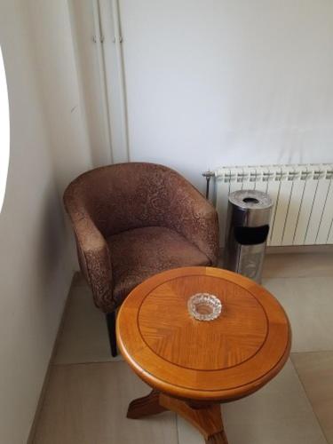 a chair and a wooden table in a room at Гостиница "Алтын Орда" in Astana