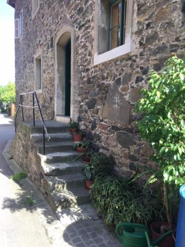 a stone building with stairs leading to a window at Appartement Donaustrand in Bergern
