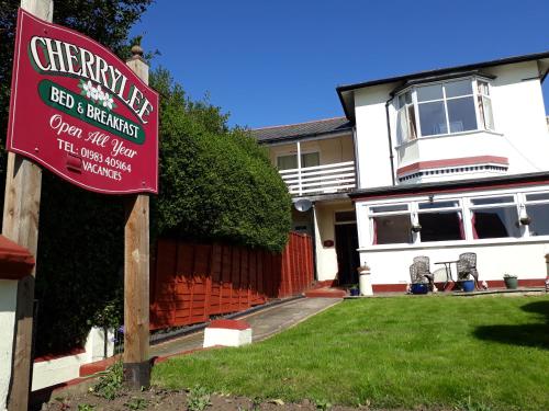 a red sign in front of a house at Cherrylee in Sandown
