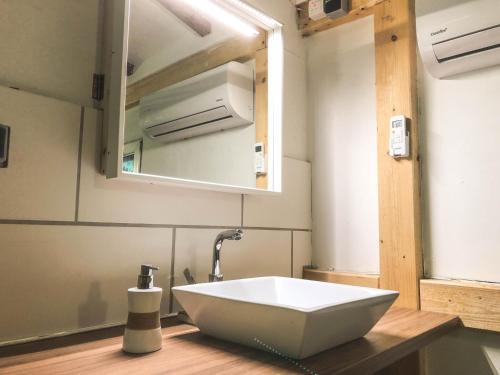 a bathroom with a white sink and a mirror at Ferienhaus-Elisabeth Bungalow-Tom Bungalow-Peter in Reinhardtsdorf