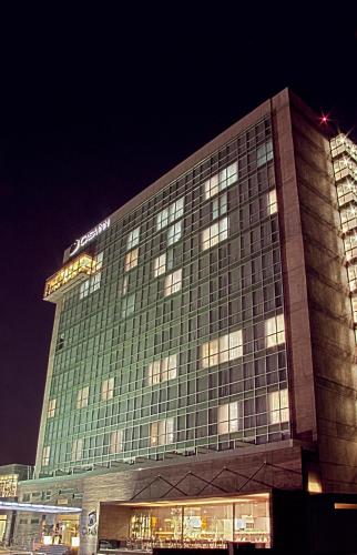 a large building with lights on it at night at Casa Inn Premium Hotel Queretaro in Querétaro