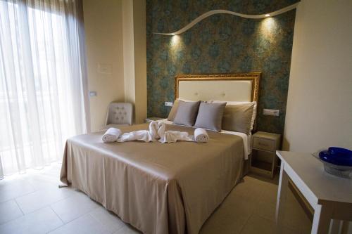 a bedroom with a bed with towels on it at Hotel Lady Mary in Milano Marittima