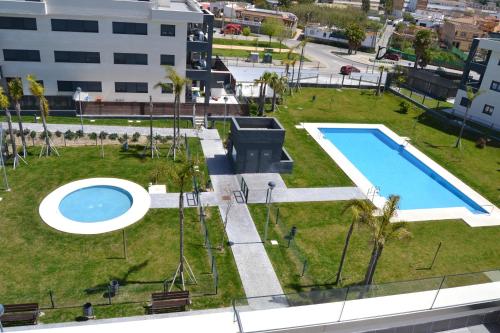 an overhead view of a park with a swimming pool at Residencial Costa Doñana (Sanlucar de Barrameda) in Sanlúcar de Barrameda