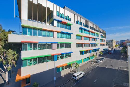 a building with colorful windows on a city street at Bay City (Geelong) Motel in Geelong