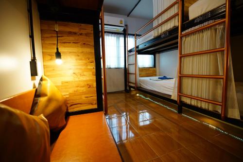 a room with two bunk beds and a bed at Sleep Owl Hostel in Bangkok