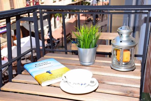 a table with a book and a cup and a lantern at Maite Urban Dreams in Barakaldo