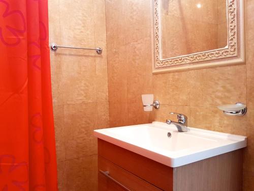 a bathroom with a sink and a mirror at Belvedere Apartments in Byala