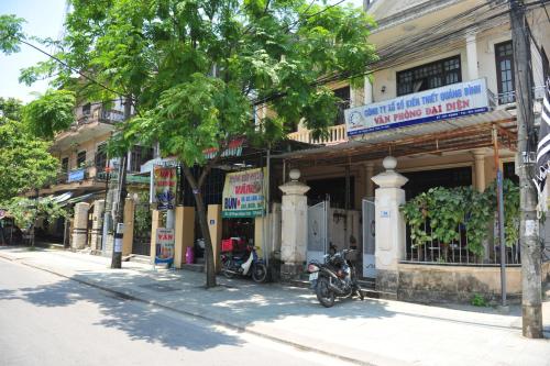 a motorcycle parked in front of a building on a street at Hue Lovely Homestay in Hue