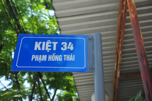 a blue sign for a trainthrow moving train at Hue Lovely Homestay in Hue